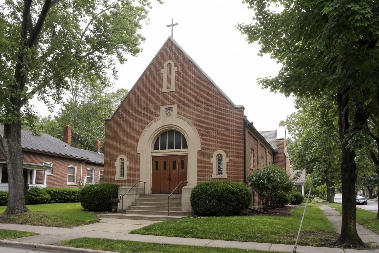 Brick church exterior on a tree-lined street