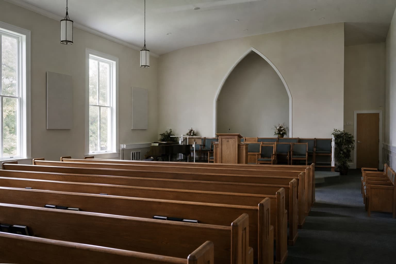 Quiet church sanctuary with wooden pews and daylight